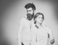 Couple in love. Barbershop concept. Fashion shot of couple after haircut. Woman on mysterious face with bearded man