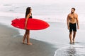 A couple in love on the beach. Surfing in Bali Indonesia. Couple of surfers walking on coast in Indonesia. Royalty Free Stock Photo