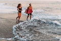 A couple in love on the beach. Surfing in Bali Indonesia. Couple of surfers walking on coast in Indonesia. Couple in love Royalty Free Stock Photo