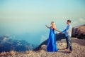 A couple in love in blue outfits on top of a mountain and the whole world at a glance Royalty Free Stock Photo