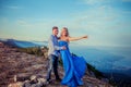 A couple in love in blue outfits on top of a mountain and the whole world at a glance Royalty Free Stock Photo