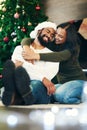Couple, love and bonding hug in christmas house or home living room in trust, festive support and love for Brazilian