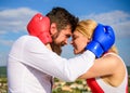 Couple in love boxing gloves hug blue sky background. Man beard and girl cuddle happy after fight. Family life happiness