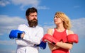 Couple in love boxing gloves sky background. Man and girl after fight. Family life reconciliation and compromise