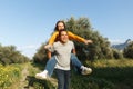 Couple in love. Boyfriend carrying his girlfriend on piggyback. Love and tenderness, dating, romance. Lifestyle concept Royalty Free Stock Photo