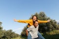 Couple in love. Boyfriend carrying his girlfriend on piggyback. Love and tenderness, dating, romance. Lifestyle concept Royalty Free Stock Photo
