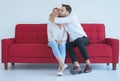 Couple in love boyfriend hugging his girlfriend on red sofa at house,Lover everything together,Happy and smiling Royalty Free Stock Photo