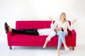 couple in love boyfriend lying down or sleep on her knee or leg girlfriend on  red sofa at home on white background, indoors Royalty Free Stock Photo
