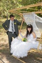 Couple in love bride and groom on swing in park