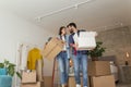 Couple in love carrying cardboard boxes while moving in together Royalty Free Stock Photo