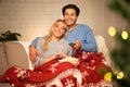 Couple in love at Christmas eve enjoying popcorn Royalty Free Stock Photo