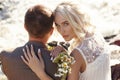 Couple in love close-up sitting on a stone on a beautiful Sunny day at sunset. Love emotions and hugs in the sun. Blonde woman Royalty Free Stock Photo