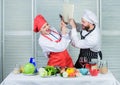 Couple in love cooking healthy recipe. Couple fight for book recipes. Improve cooking skill. Book recipes. Helpful