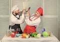 Couple in love cooking healthy recipe. Couple fight for book recipes. Improve cooking skill. Book recipes. Helpful