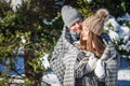 Couple in love covered with blanket hugs in winter forest Royalty Free Stock Photo