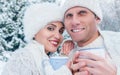 Couple in love with cups of hot tea in snow winter forest Royalty Free Stock Photo