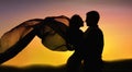 Couple in love dancing at sunset