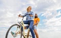 Couple in love date cycling. Couple with bicycle romantic date sky background. Let her be leader. Psychology of