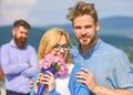 Couple in love dating while jealous bearded man watching wife cheating him with lover. Infidelity concept. Lovers hugs Royalty Free Stock Photo