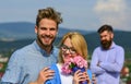 Couple in love dating while jealous bearded man watching wife cheating him with lover. Lovers hugs outdoor flirt romance Royalty Free Stock Photo