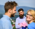 Couple in love dating while jealous husband fixedly watching on background. Lovers meeting outdoor flirt romance Royalty Free Stock Photo