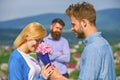 Couple in love dating while jealous husband fixedly watching on background. Couple romantic date lover present bouquet Royalty Free Stock Photo