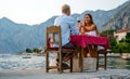 Couple in love drinking champagne wine on romantic dinner at sunset on the beach Royalty Free Stock Photo