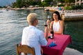 Couple in love drinking champagne wine on romantic dinner at sunset on the beach Royalty Free Stock Photo