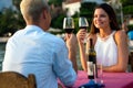 Couple in love drinking champagne wine on romantic dinner at sunset on the beach Royalty Free Stock Photo