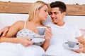 Couple in love drinking morning coffee in bed Royalty Free Stock Photo