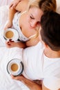 Couple in love drinking morning coffee in bed Royalty Free Stock Photo