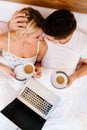 Couple in love drinking morning coffee in bed Royalty Free Stock Photo