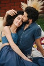 Couple in love, drinking rose wine, having picnic on lawn in their courtyard Royalty Free Stock Photo