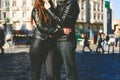 Couple in love embraced in an urban scene, lower half body photo, legs