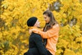 A couple in love embraces each other in the autumn forest. A young man and a girl are walking, a guy is holding a girl in his arms Royalty Free Stock Photo