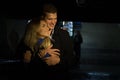 Couple in love embracing against a dark background, night, rain, buildings in the city, a park, smiling, attraction. the Royalty Free Stock Photo