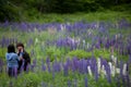 Couple in Love Embracing in Lupine Flowers