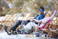 Couple enjoy in sun loungers on ski terrain Royalty Free Stock Photo