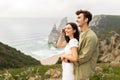 Couple in love enjoying beautiful view at ocean shore, man embracing lady from back, looking away, having romantic date Royalty Free Stock Photo
