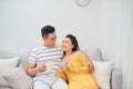 Couple in love enjoying their free time, sitting on a couch,drinking coffee and chatting Royalty Free Stock Photo