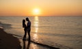 A couple in love is experiencing romantic tender moments at sunset on the beach. Young lovers on summer vacation Royalty Free Stock Photo