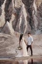 Couple in love in fabulous mountains hugging, Martian landscape. Lovers walk in the mountains in the summer