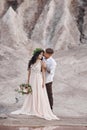 Couple in love in fabulous mountains hugging, Martian landscape. Lovers walk in the mountains in the summer