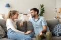 Couple in love or friends sitting in living room