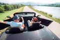 Couple in love getting into the convertable auto and starting a trip. Couple honeymoon or vacation concept image Royalty Free Stock Photo