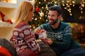 Couple in love giving gift Christmas to each other