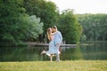 A couple in love, a guy and a girl beautifully hug each other on the shore of the lake