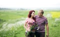 Couple in love guy and girl in a field of white daisies and green grass Royalty Free Stock Photo