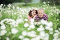 Couple in love guy and girl in a field of white daisies and green grass Royalty Free Stock Photo