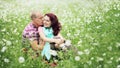 Couple in love guy and girl in a field of white daisies and green grass Royalty Free Stock Photo